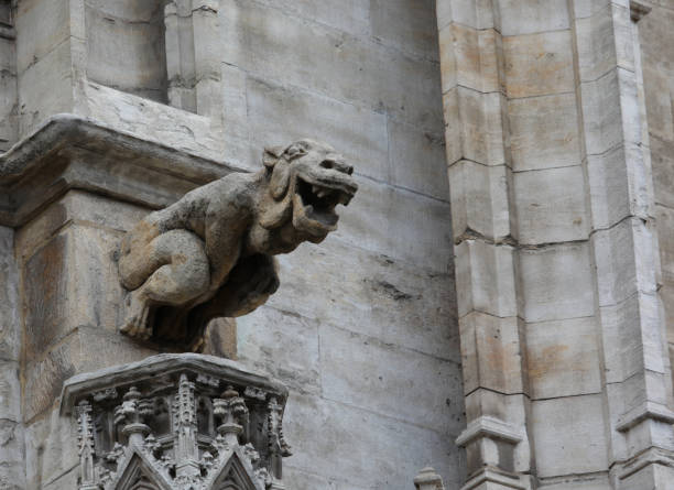 istock Monstrous statue with almost human features called gargoyle on the historic building 1423433275