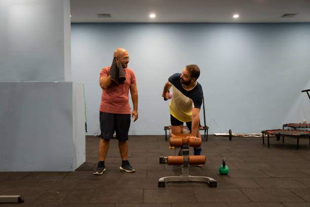 istock Real men's bodies train in the gym 1423433371