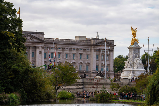 Buckingham Palace, SW1A 1AA London, England the United Kingdom - December 2023: Victoria Memorial and The Royal residence in central London, England. Located in the City of Westminster, This Buckingham Palace photo shows the royal residence in London and the administrative headquarters of the monarch of the United Kingdom.