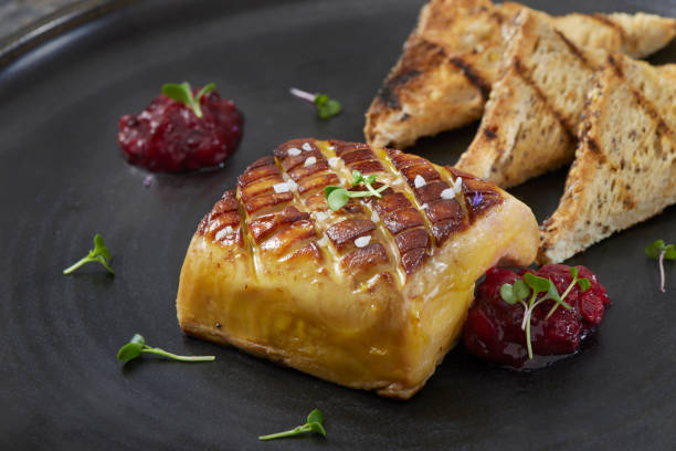 Seared Foie Gras Seared Foie Gras with Red Current Jam and Grilled Sourdough Bread foie gras stock pictures, royalty-free photos & images