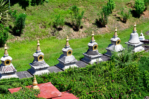 Nyizergang, Punakha district, Bhutan: Khamsum Yulley Namgyal Chorten - line of stupas / chortens in the gardens of the main temple - Buddhist temple built by HM The Queen Mother, Ashi Tshering Yangdon Wangchuck, dedicated to peace in the world and in Bhutan.