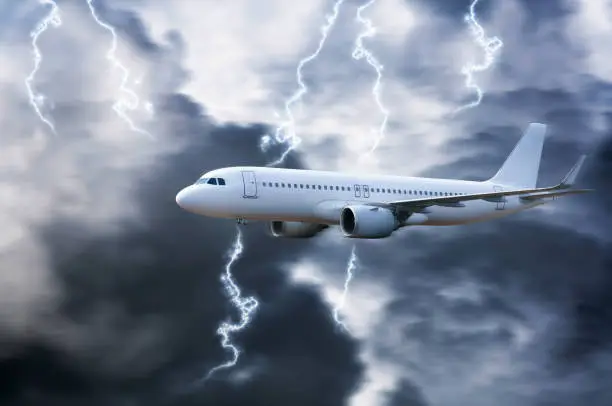 Photo of Airplane in the sky with thunder and lightning,The plane flies in terrible thunderstorm,Concept of climate weather