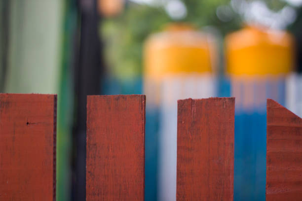 Red Wooden Fence with blur background in the garden