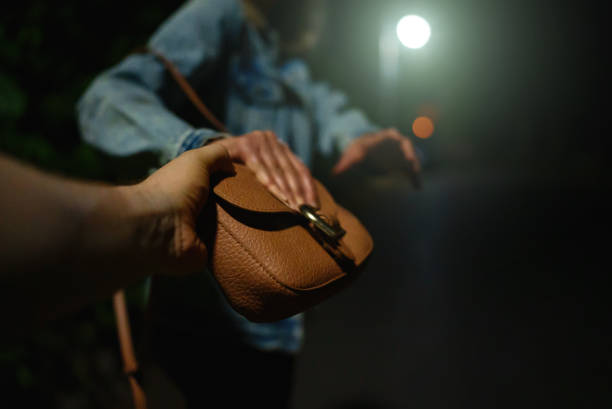 Thief snatches bag from woman on the night street. Thief snatches bag from woman on the night street. interception stock pictures, royalty-free photos & images