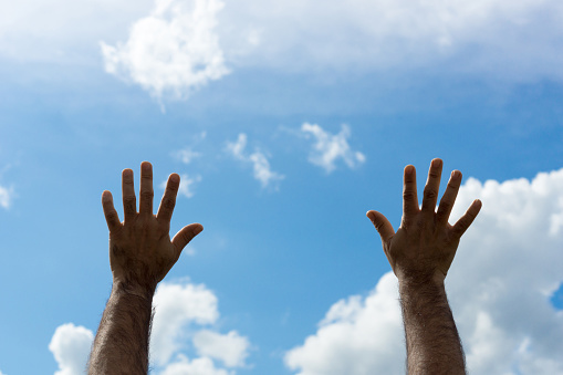 Man hands up in the air blue sky. Hands in the air, hands in the sky, hands above head, Faith and hope concept.