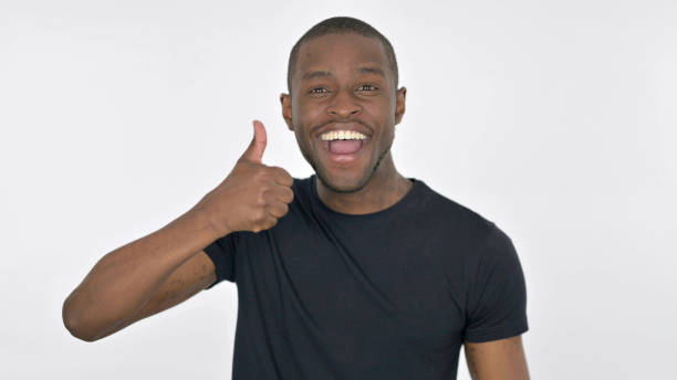 istock Thumbs Up by Young African Man on White Background 1423450225