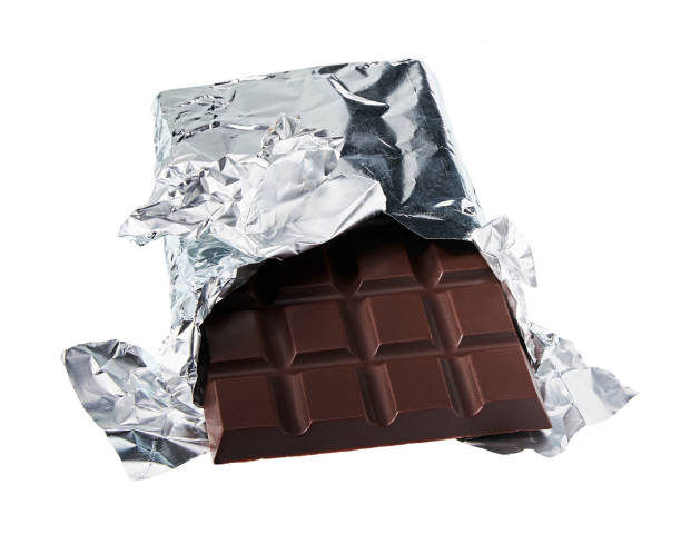 istock Dark chocolate on a foil isolated on white background, 1423451824