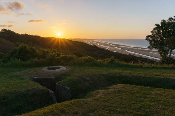 View over Omaha beach during sunset with bunker for machine gun and trench system called Widerstandsnest WN 60, Colleville-sur-Mer, Normandy, France stock photo