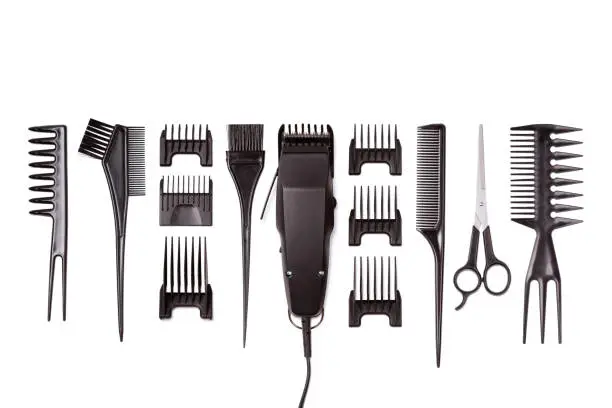 Professional hair clipper with set of nozzles of different sizes isolated on white background. Top view. Copy space for text