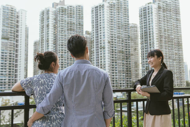 home ownership backview of an asian heterosexual couple looking to buy a new home in a - Navigating Petaling Jaya's Residential Market: The Role of Professional Real Estate Agents