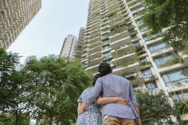 Home Ownership - Backview of Asian heterosexual couple celebrating the purchase of their new home Home Ownership - Backview of Asian heterosexual couple celebrating the purchase of their new home happy malay couple stock pictures, royalty-free photos & images