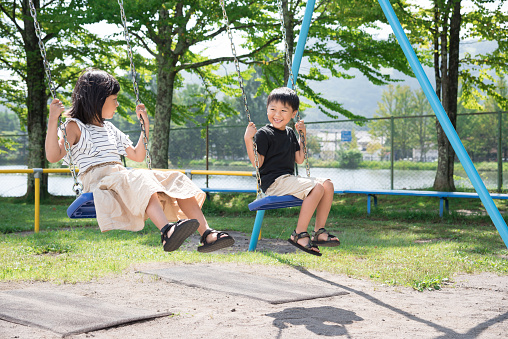 Japanese child on a swing with a smile