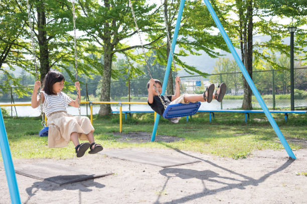 istock Japanese child on a swing with a smile 1423456527