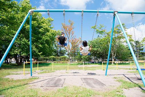 Japanese child on a swing with a smile