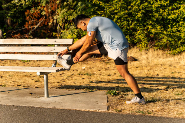 istock Athlete Stretching with Continuous Glucose Monitor Transmitter 1423457718