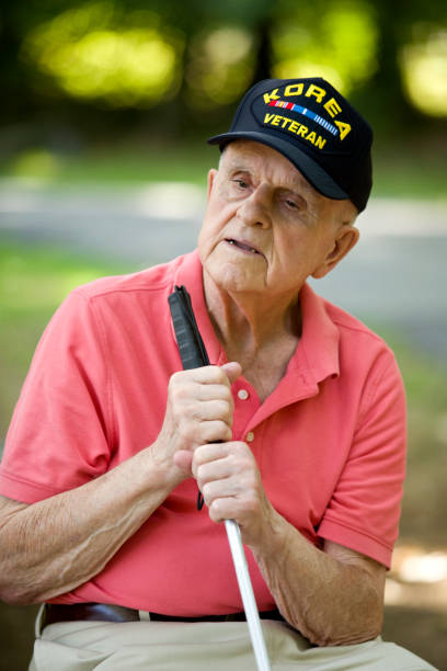 istock Blind Korean War Veteran holding walking stick 1423458056