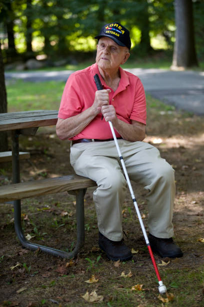 istock Blind Korean War Veteran sitting on park bench contemplating 1423458071
