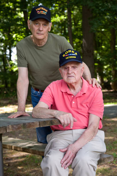 istock Korean War Veteran and Vietnam Veteran looking at camera 1423458151