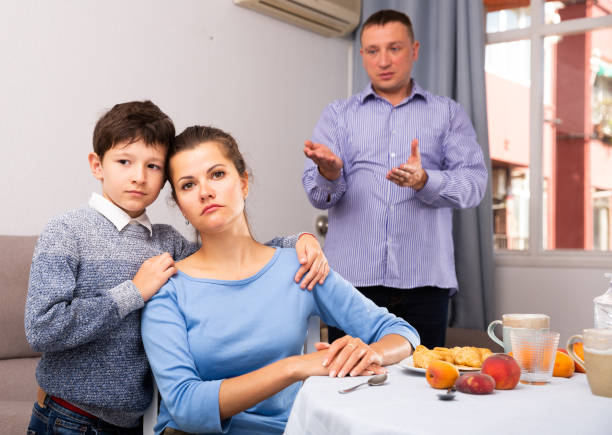 istock Frustrated woman and son after quarrel with husband 1423458361