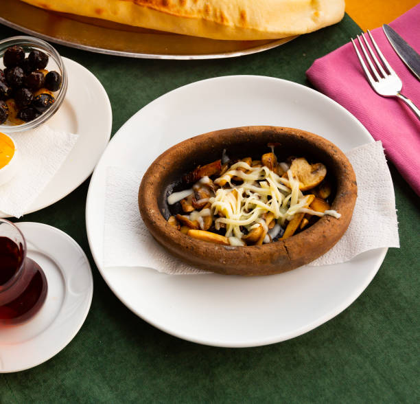 istock Turkish mushroom saute with grated cheese in earthenware dish 1423458819