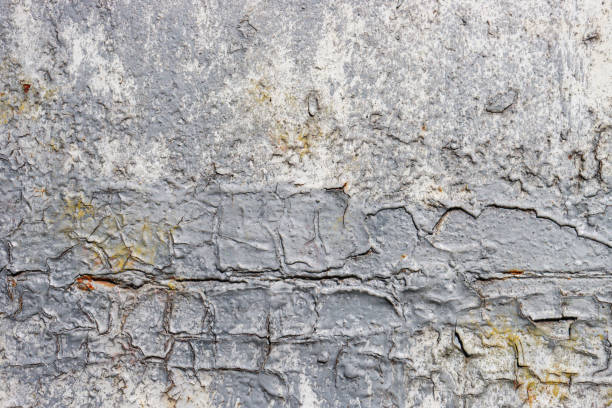 istock Abstract background from an old concrete wall damaged by the weather. 1423473748
