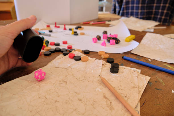 istock Player rolls a 20 sided dice (d20) druing a role playing table top game 1423474857
