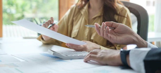istock Two professional business people discussing business plan, working at contemporary office. 1423481205