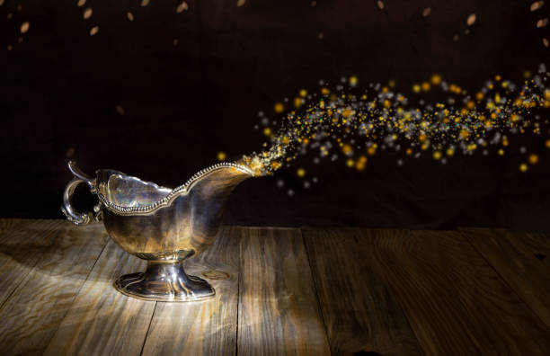 istock Wish Lamp on wood table - Genie glitters Coming out from Bottle 1423481633