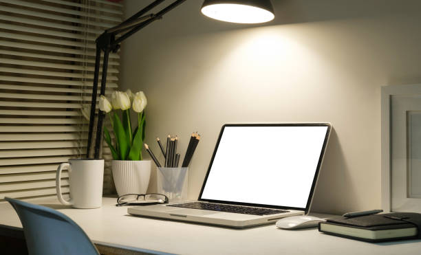 istock Home office laptop computer, picture frame, houseplant and coffee cup on white table. 1423483901