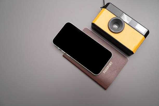 istock vintage camera, smartphone, passport  on gray background, 1423485259