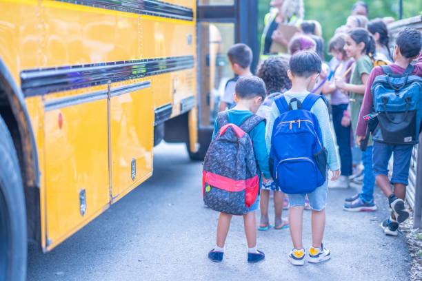 istock Children getting onto a School Bus 1423488625
