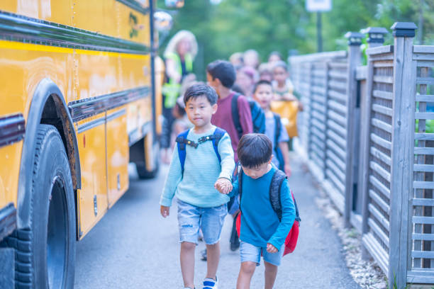 istock Children getting onto a School Bus 1423488649