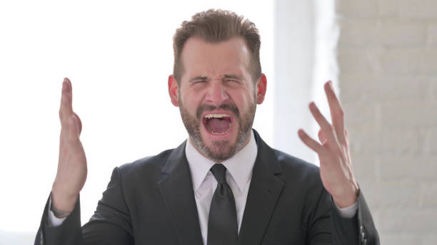 istock Middle Aged Businessman Shouting and  Screaming, Feeling Crazy 1423490046