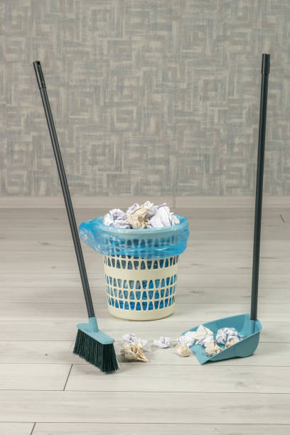istock The process of garbage collection using a brush and a dustpan in the trash. 1423490656