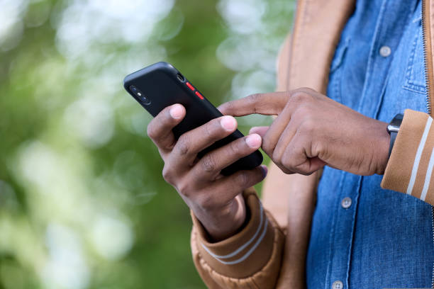 istock Young black freelancer works online using a smartphone anywhere 1423492583