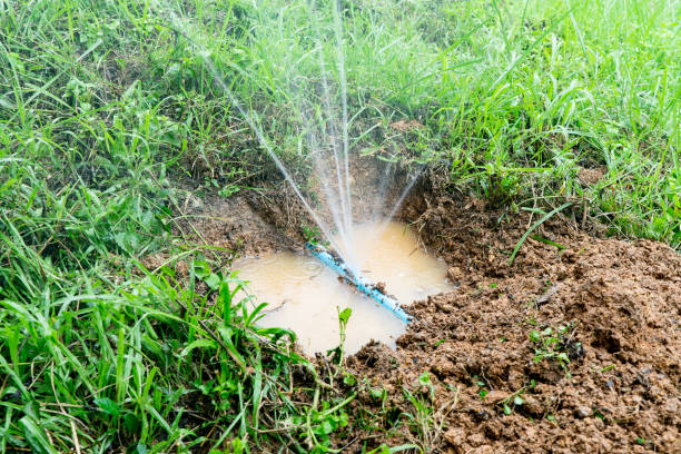 Water pipe break,leaking from hole in a hose  connection joint of plastic pipes Water supply system,selective focus stock photo