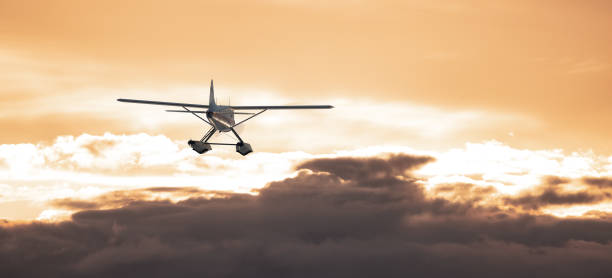 istock Seaplane flying over the Dramatic Cloudscape on the Pacific Ocean Coast. 1423498944