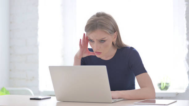 istock Angry Woman Working on Laptop in Office 1423502538