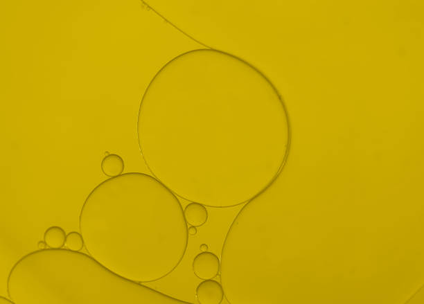 Interesting of art image with oil and water bubbles pattern on golden-yellow light gradient effects background.