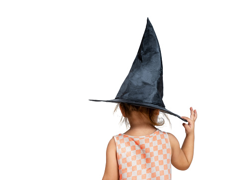 Girl holding witch hat view from back isolated on white background