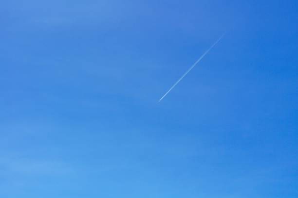 istock A passenger jet leaves a mark above the blue skies. 1423509148