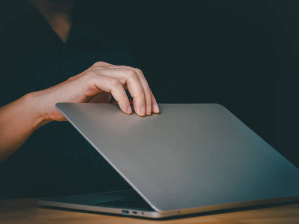 Man open or close laptop cover lid.
