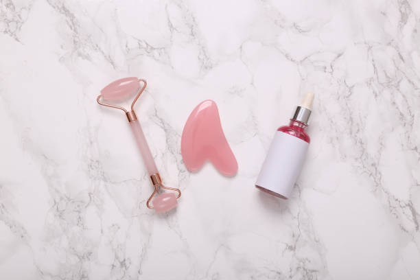 istock jade massage roller with guasha stone and serum bottle on marble background 1423510748
