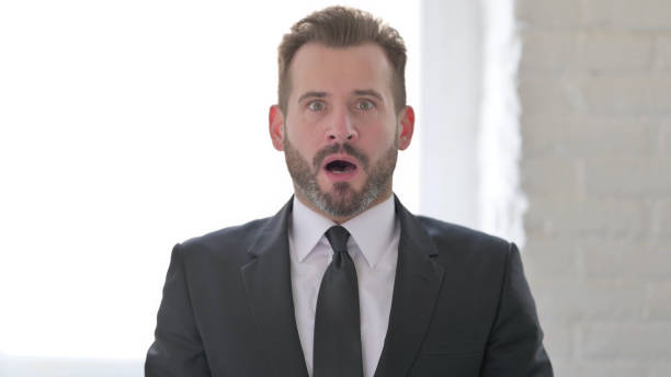 istock Shocked Middle Aged Businessman Wondering in Awe 1423513638