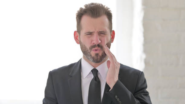 istock Sick Middle Aged Businessman having Toothache 1423515117