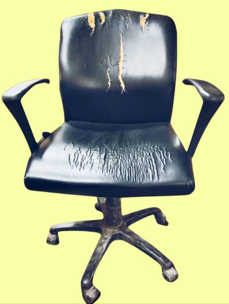 Old damaged used black dirty office chair officechair with rolling casters wheels and torne leather isolated stock photo closeup view image stock photo