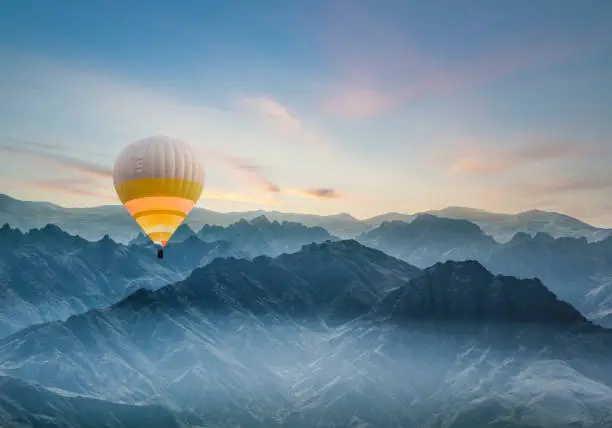 Hot air balloon flying over rocky mountains  in TURKEY