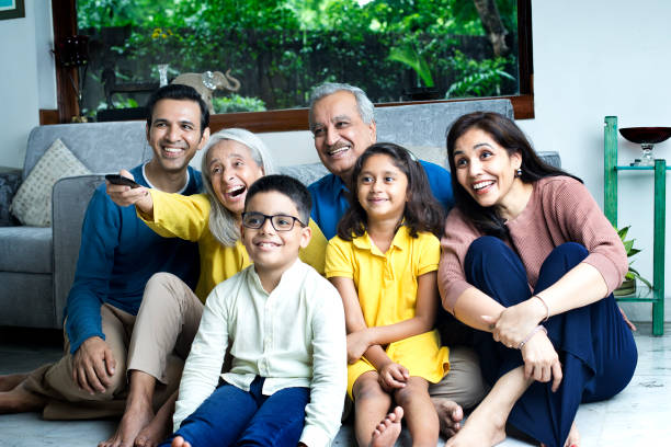 istock Multi generation family watching tv at home 1423520839