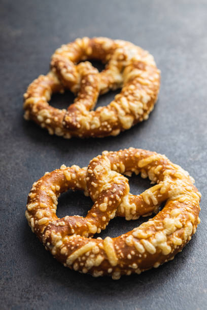 istock German bread pretzel with baked cheese on kitchen table. 1423523317