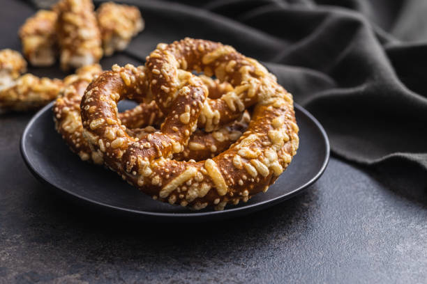 istock German bread pretzel with baked cheese on kitchen table. 1423523340